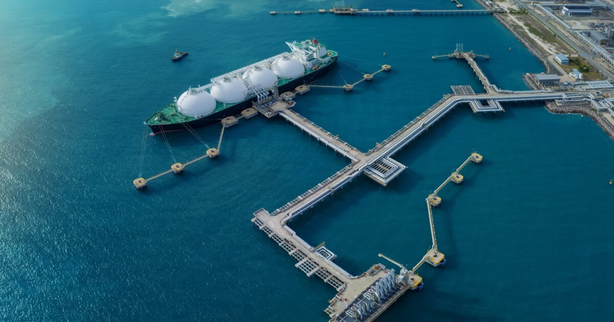 Aerial view of an LNG terminal with a moored carrier and pipeline jetties — critical national infrastructure